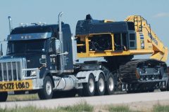 Blue truck moving a crane